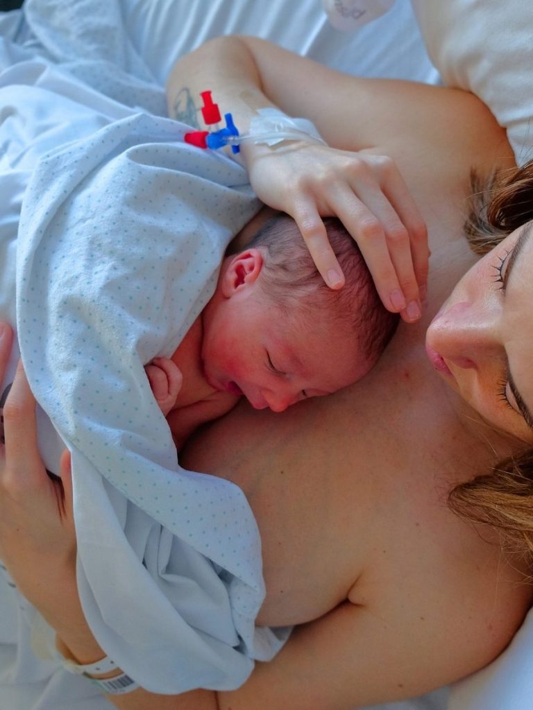 childbirth mom holding baby